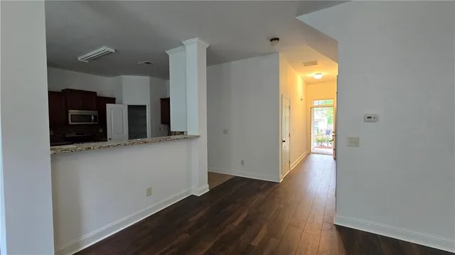 a view of a kitchen with a sink and a refrigerator