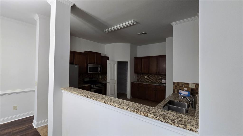 2275 Copper Trail Lane Northeast Buford, GA 30519 - Photo 17 of 39 a kitchen with stainless steel appliances granite countertop a refrigerator and a stove