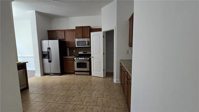 a kitchen with stainless steel appliances a refrigerator and a stove