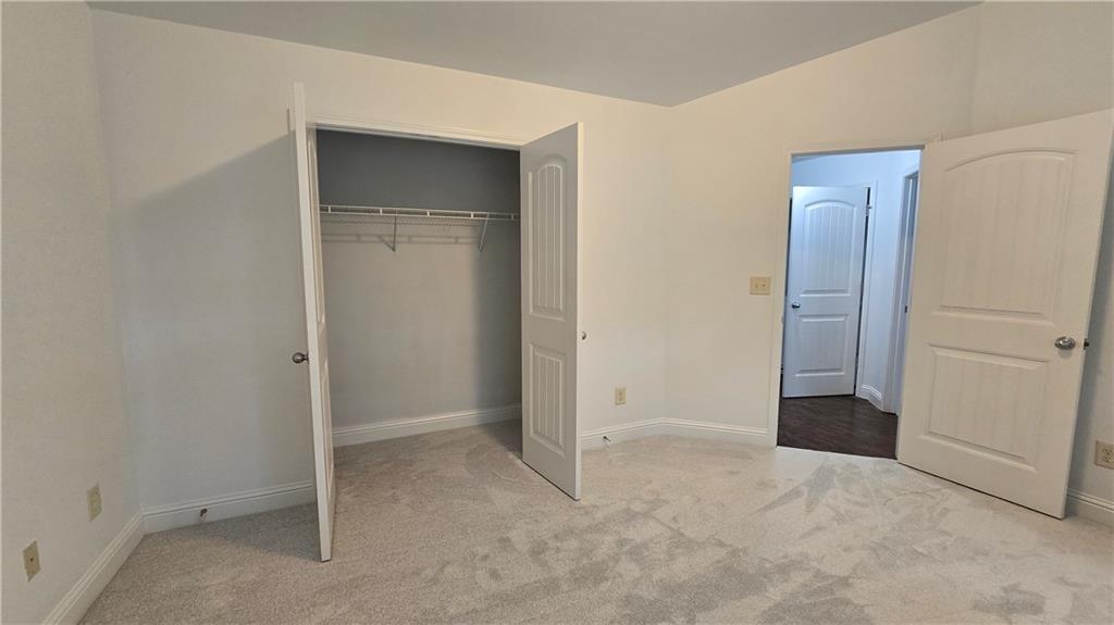 2275 Copper Trail Lane Northeast Buford, GA 30519 - Photo 24 of 39 an empty room with closet and mirror