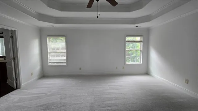 an empty room with windows and closet