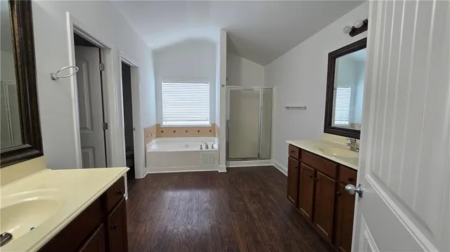 a bathroom with a sink a mirror and a shower