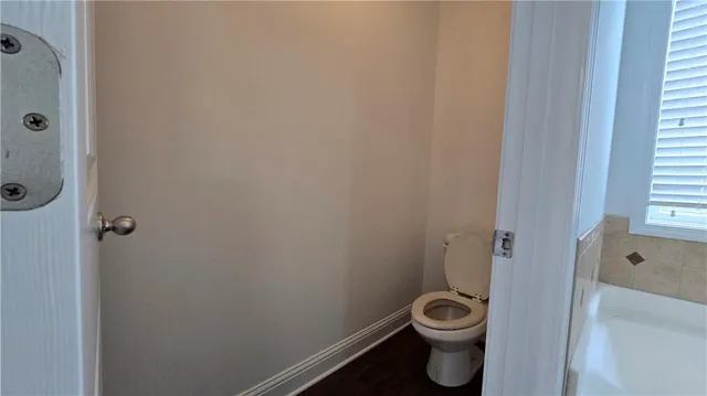 a bathroom with a toilet and a shower curtain