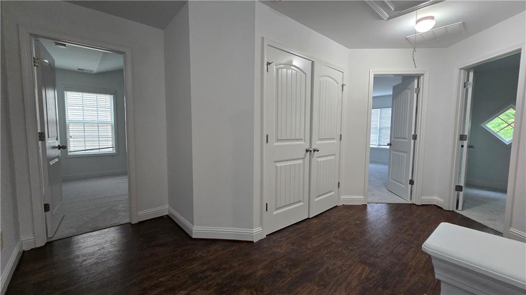 2275 Copper Trail Lane Northeast Buford, GA 30519 - Photo 7 of 39 a view of an empty room with wooden floor and a bathroom