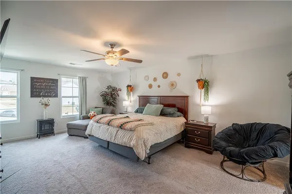 a bedroom with a bed couch and window
