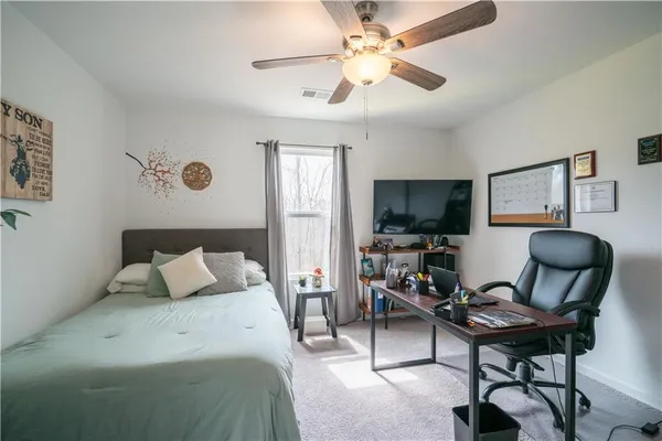 a bedroom with a workspace