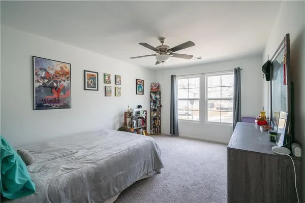 a bed room with a bed and a large window