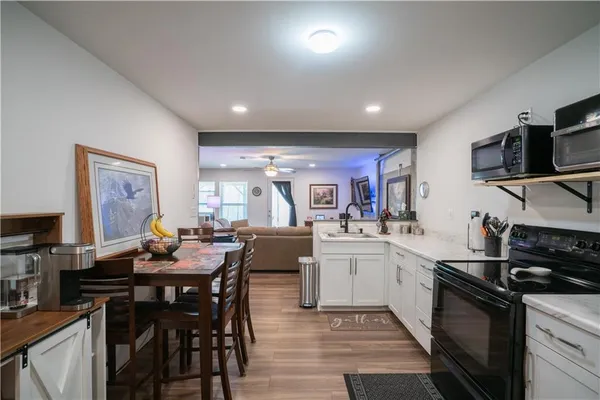 a kitchen with stainless steel appliances kitchen island granite countertop a sink and cabinets