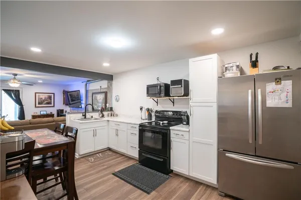 a kitchen with stainless steel appliances granite countertop a refrigerator and a stove top oven