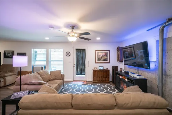 a living room with furniture and a flat screen tv