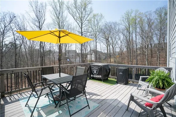 a view of a roof deck with chair and table