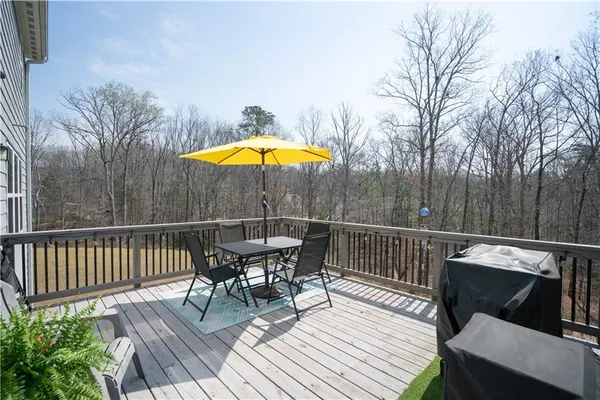 a view of a deck with furniture and wooden floor