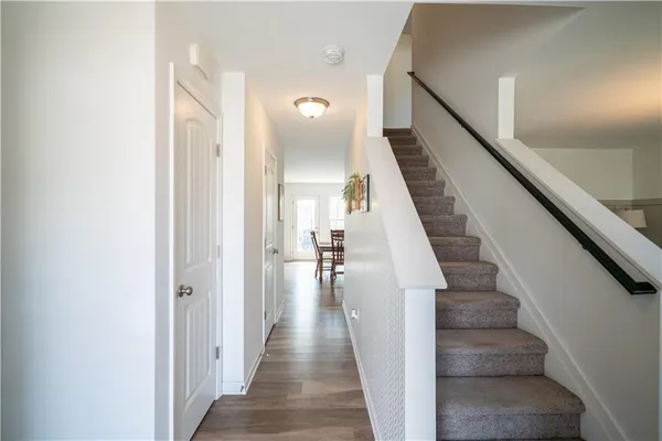 a view of a hallway with wooden floor and entryway