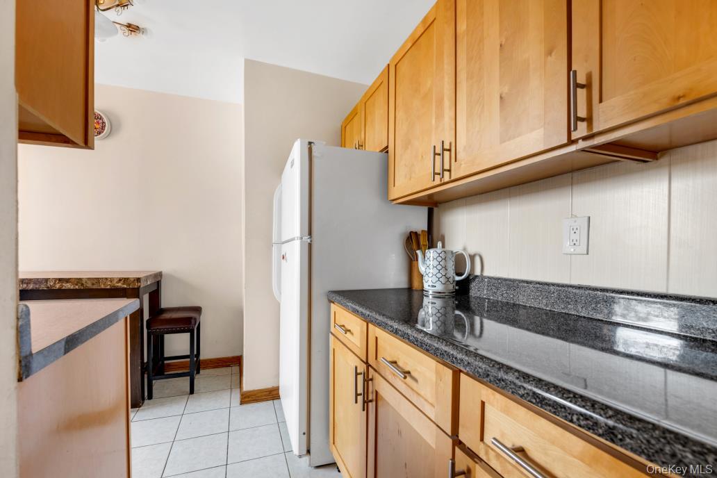108-50 62nd Drive, Unit 3F Queens, NY 11375 - Photo 5 of 11 a kitchen with stainless steel appliances granite countertop a refrigerator and a stove top oven