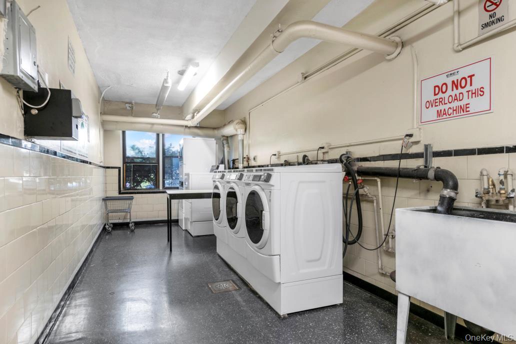 108-50 62nd Drive, Unit 3F Queens, NY 11375 - Photo 10 of 11 a utility room with dryer and washer