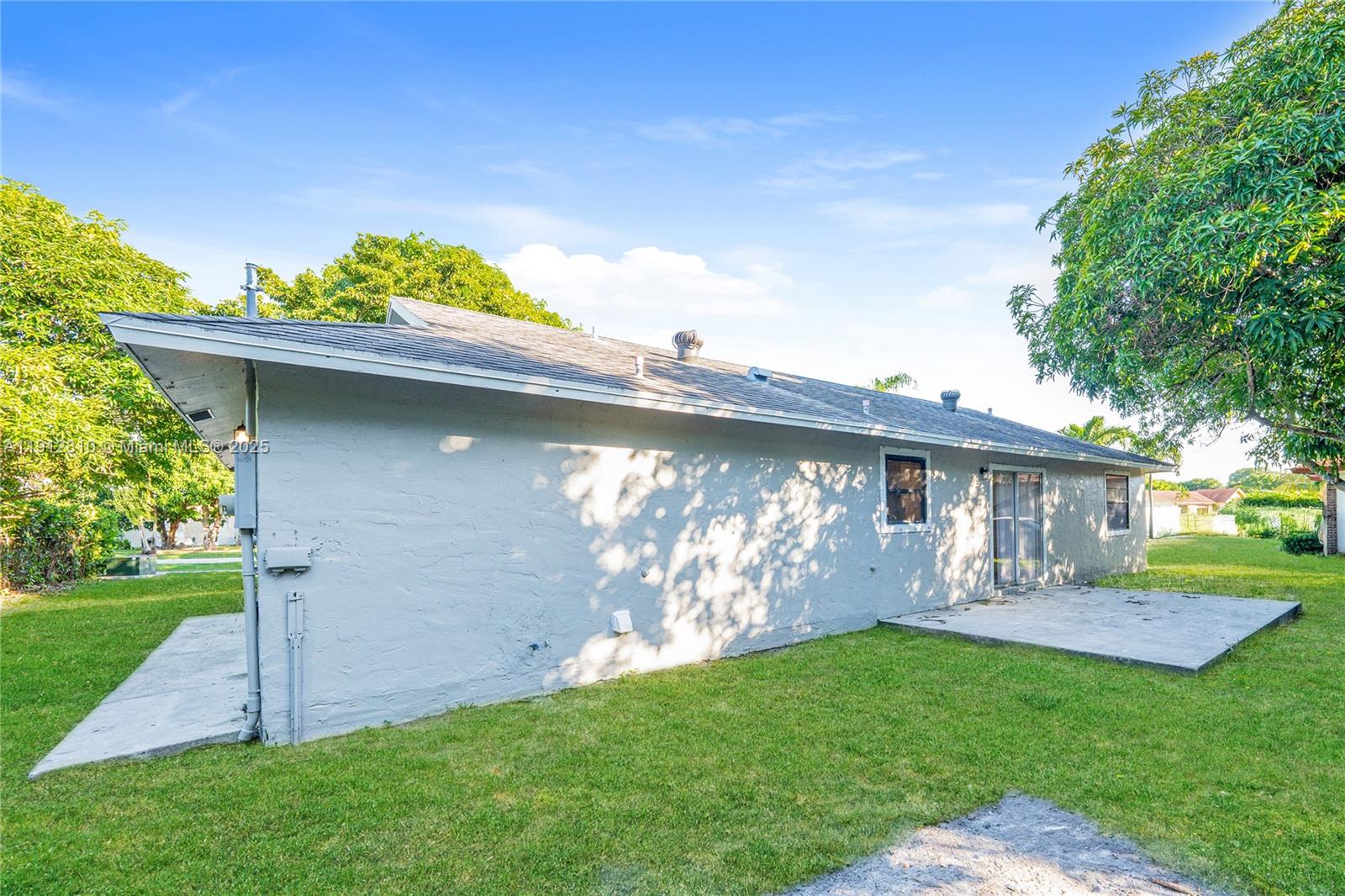 586 Udell Lane Delray Beach, FL 33445 - Photo 14 of 16 a front view of a house with garden