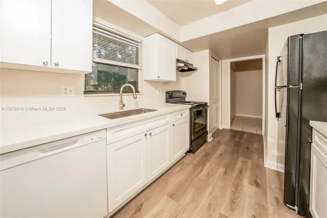 a kitchen with a sink stove and refrigerator