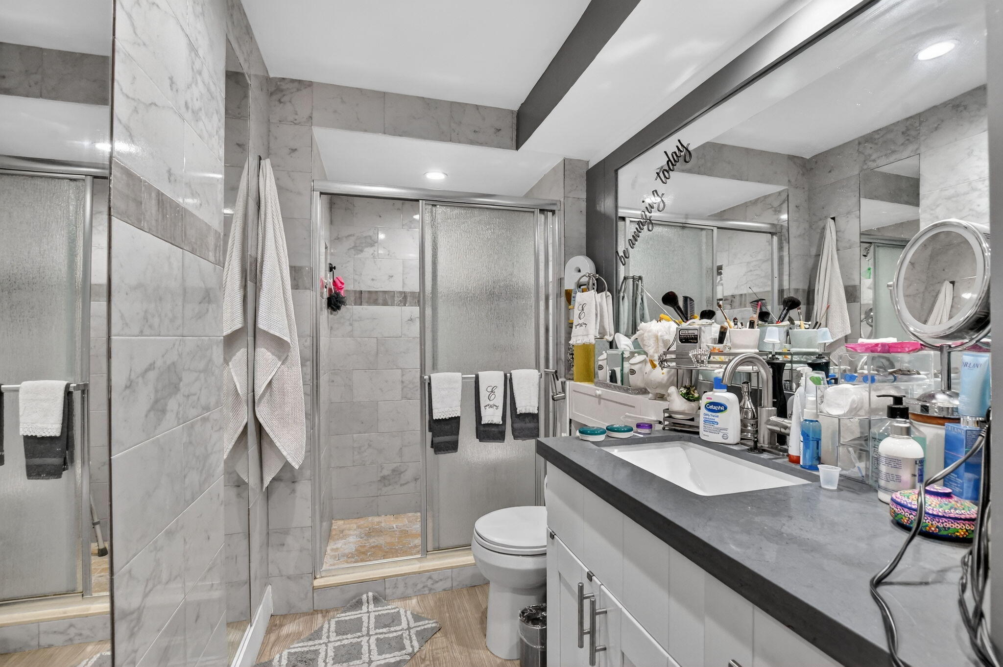 450 Northwest 20th Street, Unit 1140 Boca Raton, FL 33431 - Photo 14 of 29 a bathroom with a granite countertop sink a toilet a mirror and shower