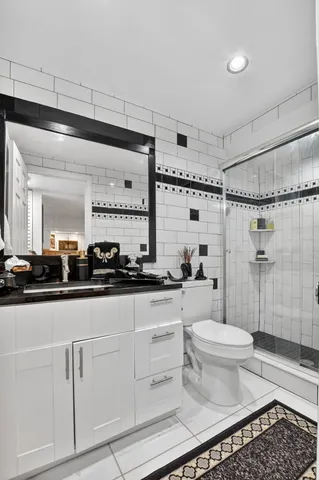 a bathroom with a sink toilet a mirror and shower