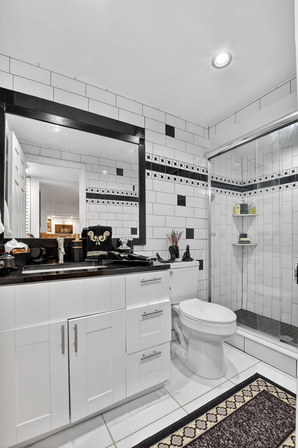 450 Northwest 20th Street, Unit 1140 Boca Raton, FL 33431 - Photo 17 of 29 a bathroom with a sink toilet a mirror and shower