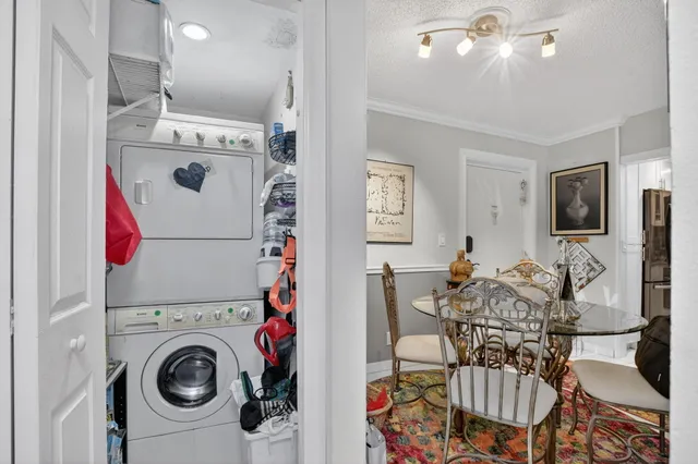 a view of a dining room with furniture and a flat screen tv