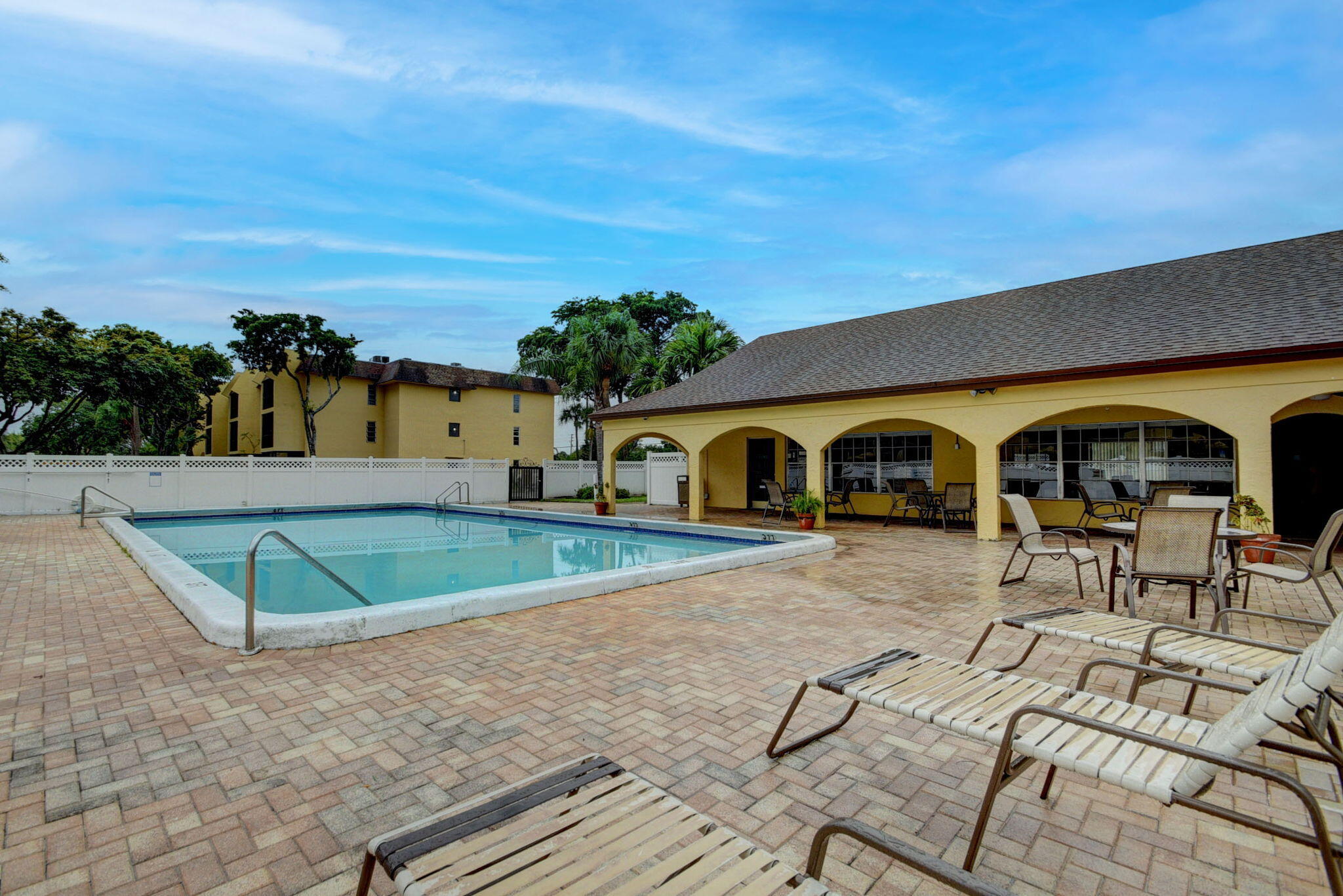 450 Northwest 20th Street, Unit 1140 Boca Raton, FL 33431 - Photo 27 of 29 a view of a swimming pool with a lounge chairs
