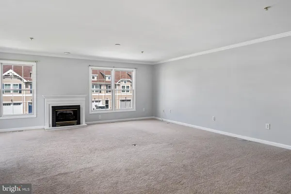 a view of a livingroom with a fireplace and window