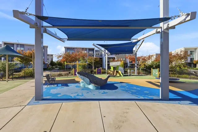 a view of a patio with a table and chairs under an umbrella