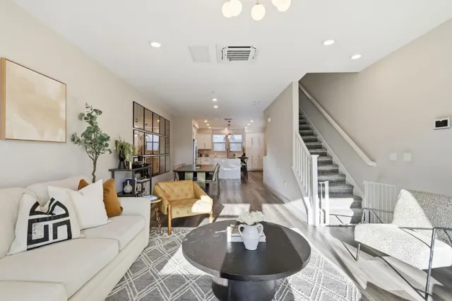 a living room with furniture and a dining table