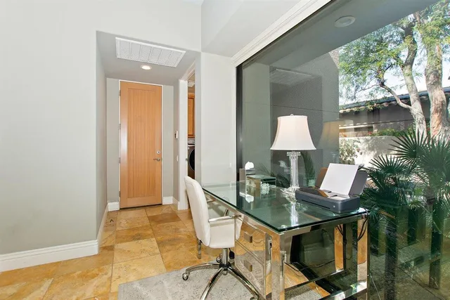 a bedroom with a bed couch and a chandelier