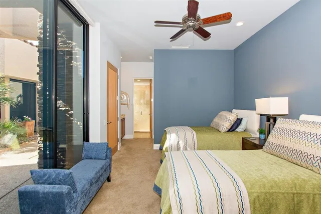 a bedroom with a bed and a flat tv screen on dresser