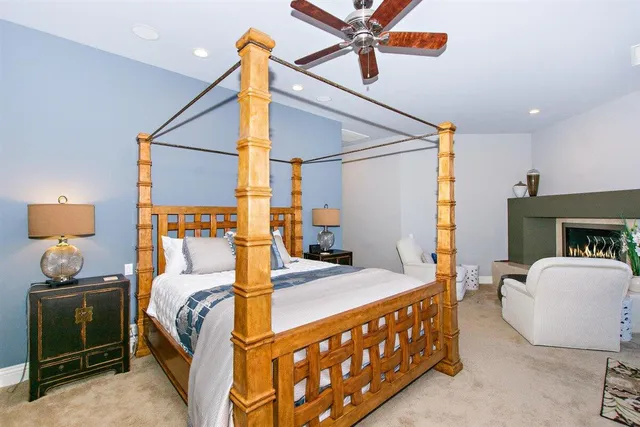 a living room with furniture a fireplace and a floor to ceiling window