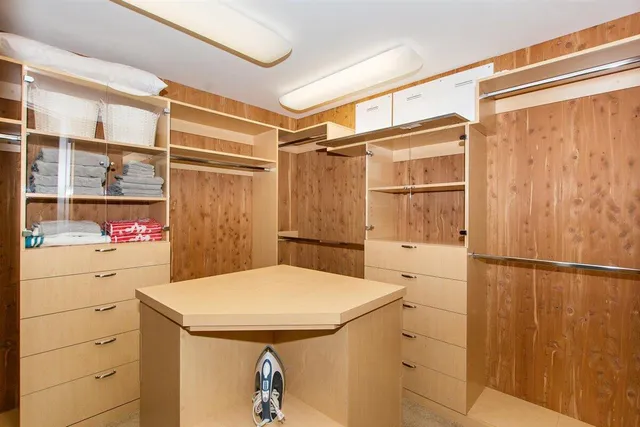 a view of bathroom with a sink and mirror