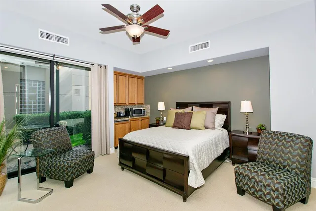 a bedroom with a bed and a lamp