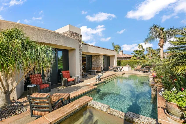 a view of a patio with lake view and a garden