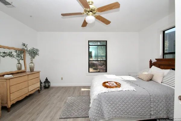 a bedroom with bed and a window
