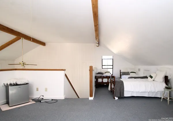 a bed room with a bed and a television