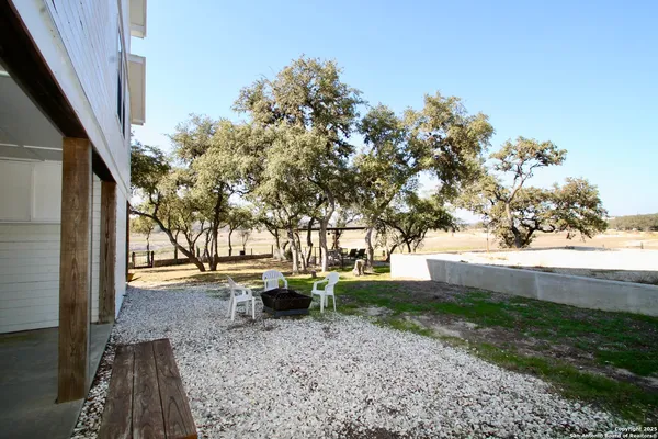 a view of yard with tree in the background