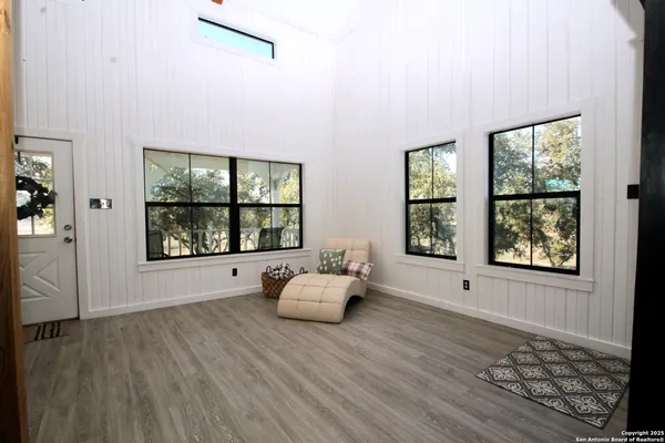 a view of a livingroom with wooden floor and stairs