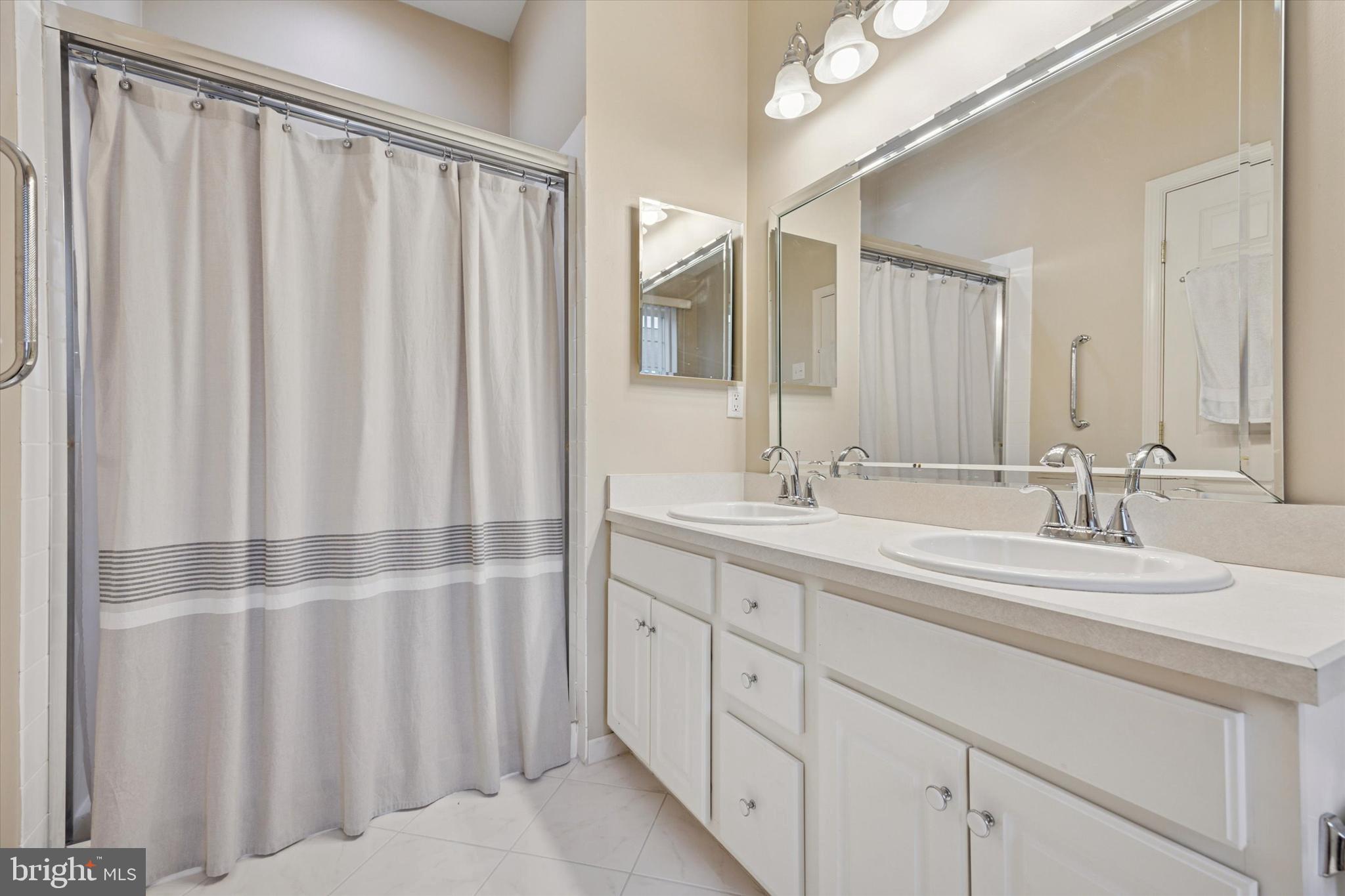 1105 Maxwell Manor Warminster, PA 18974 - Photo 10 of 15 a bathroom with a double vanity sink and mirror