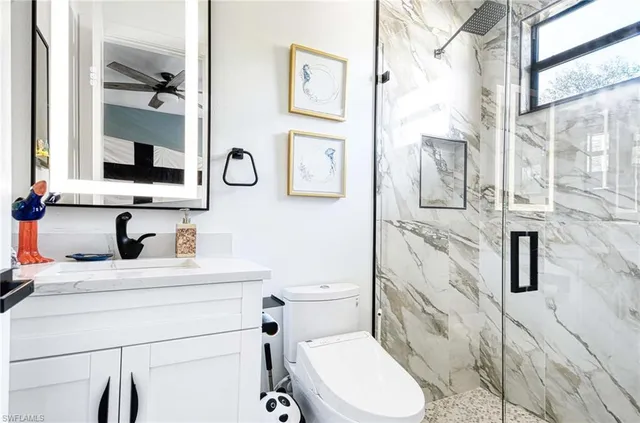 a bathroom with a toilet sink and mirror