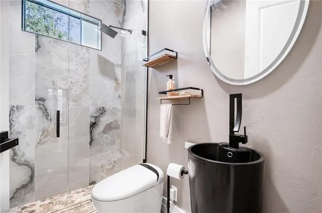 a bathroom with a toilet a sink and a shower