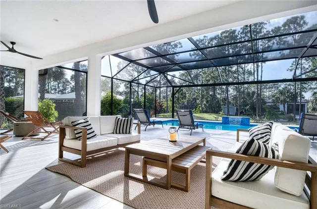 a living room with furniture a rug and a large window