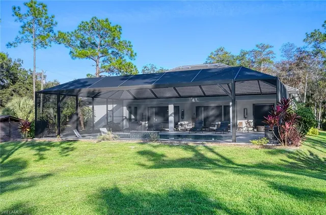 a view of a house with swimming pool and sitting area