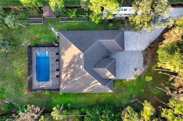 an aerial view of a house with a yard