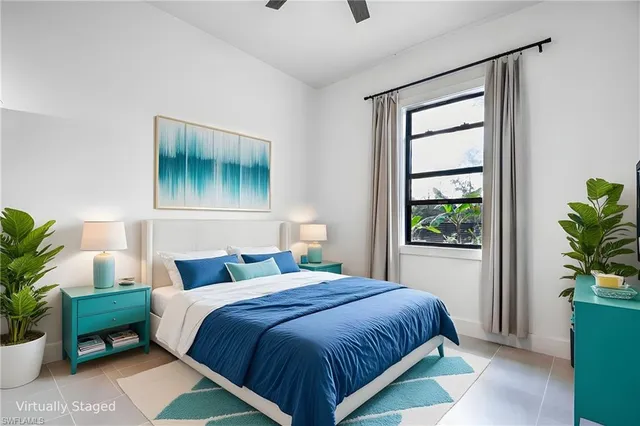 a bedroom with a bed and a potted plant