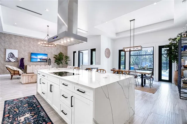 a large white kitchen with a large island