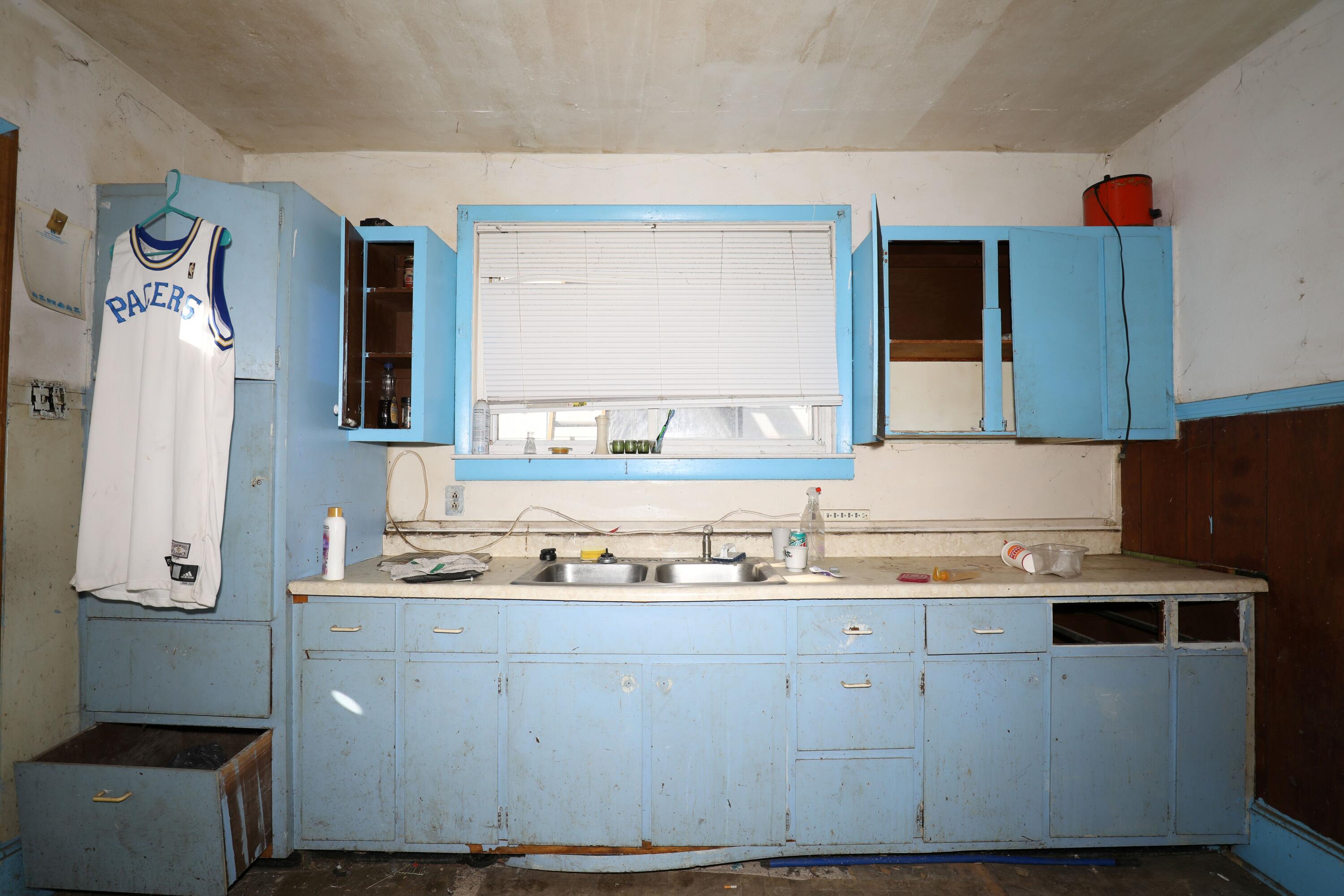 1615 West 1st Street Marion, IN 46952 - Photo 18 of 42 a kitchen with a sink a stove and cabinets