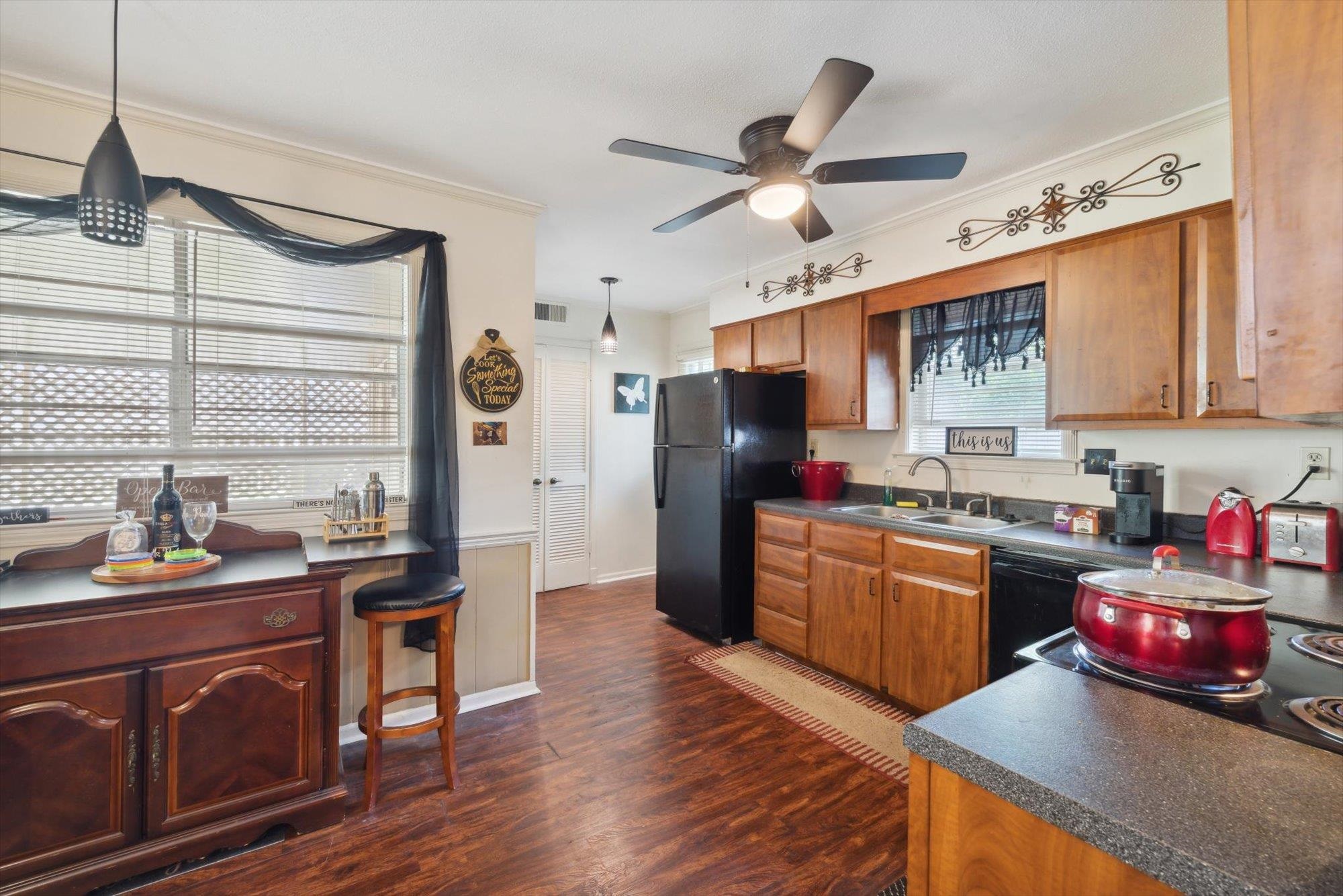 2936 Falkirk Road Memphis, TN 38128 - Photo 16 of 25 a kitchen with granite countertop stainless steel appliances a sink cabinets and wooden floor