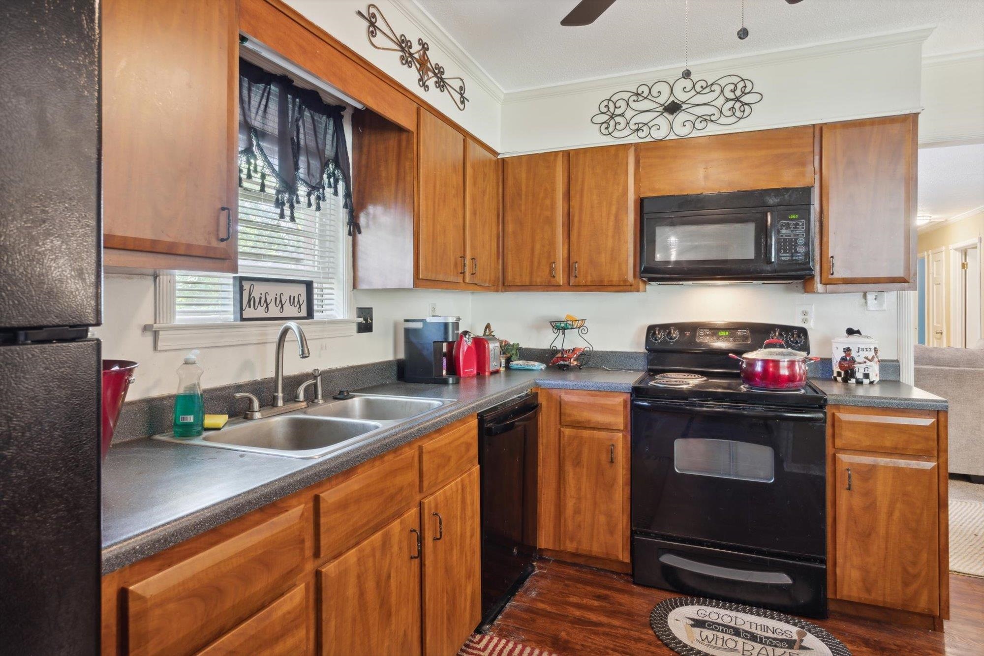 2936 Falkirk Road Memphis, TN 38128 - Photo 17 of 25 a kitchen with stainless steel appliances a stove sink and microwave